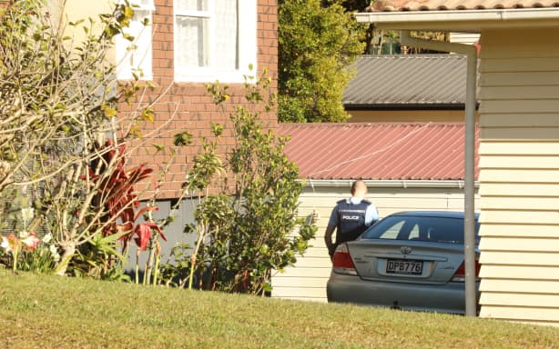 Police vehicles and ambulance at a cordon in Glendene, West Auckland