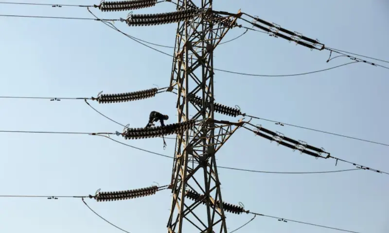 Electricity transmission towers at sunset in Pakistan