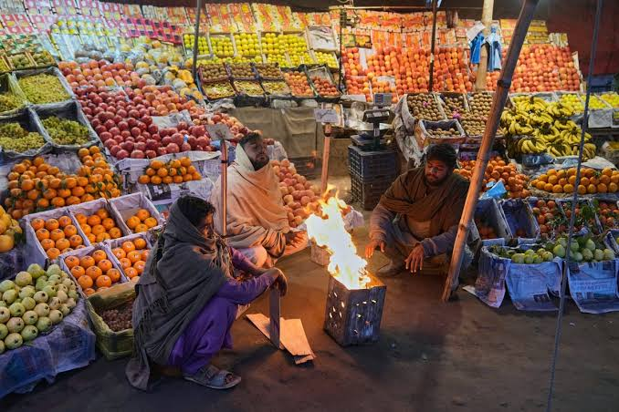 Traders at Pakistan Stock Exchange screens showing market indices