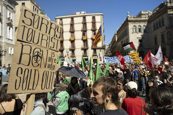 Crowd of protesters in a European city square with banners