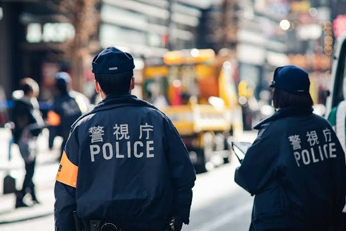 Police investigators examining seized mobile devices and bank records related to voice phishing and money laundering