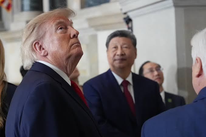 Silhouettes of AI code overlaid on Chinese and U.S. flags