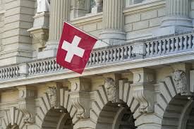 Swiss parliament building with Swiss flag; symbolic image for financial reform