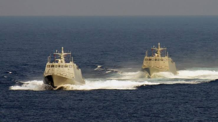 Chinese fishing vessel and coast guard cutter at sea