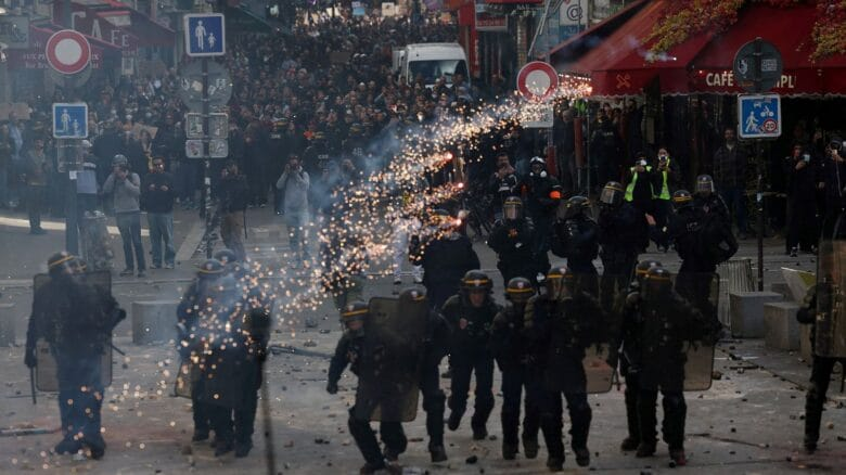 Fire and police near Piazza del Duomo in Milan during clashes