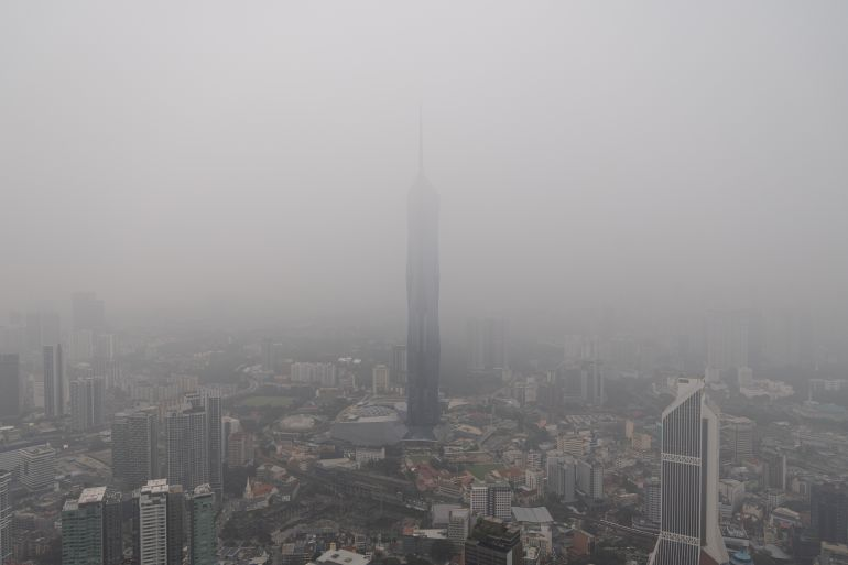 Hazy skyline of a Southeast Asian city with reduced visibility due to air pollution