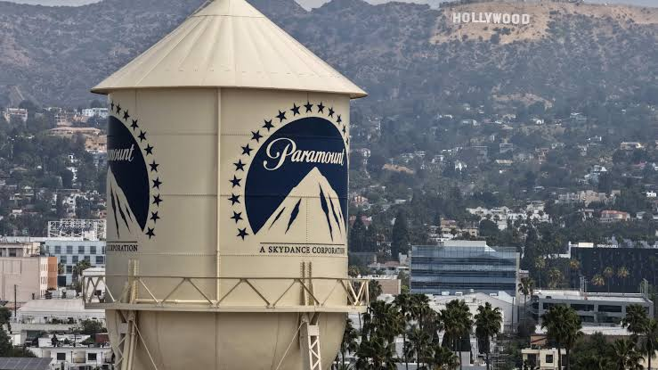 Paramount and Warner Bros. logos on filing cabinet, with courthouse steps in background
